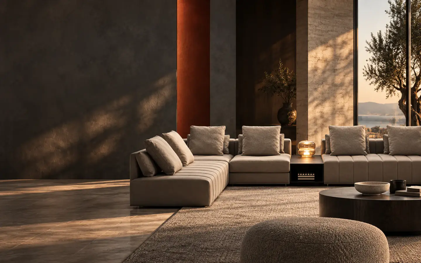 Architectural living room with sculptural seating, warm stone and evening light